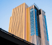 High-rise residential building in a bustling urban environment.